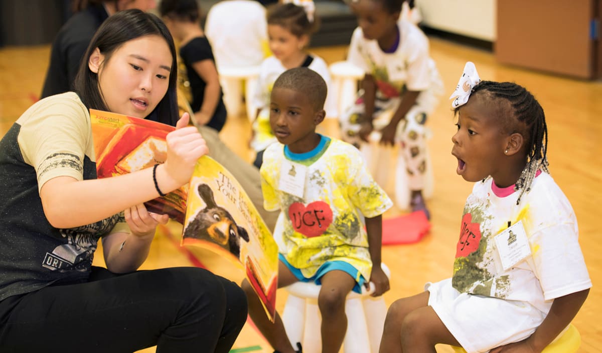 teacher sharing book with children