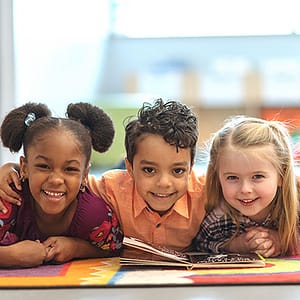 children smiling with book
