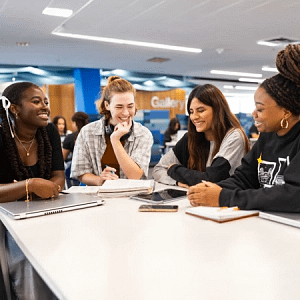Four students collaborating at table