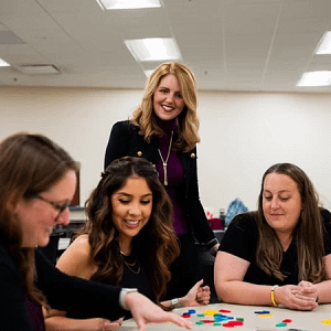 Sarah Bush with three students working together